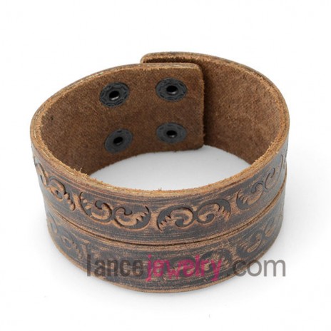 Cool bracelet decorated with brown patterned leather and six snap fastener 
