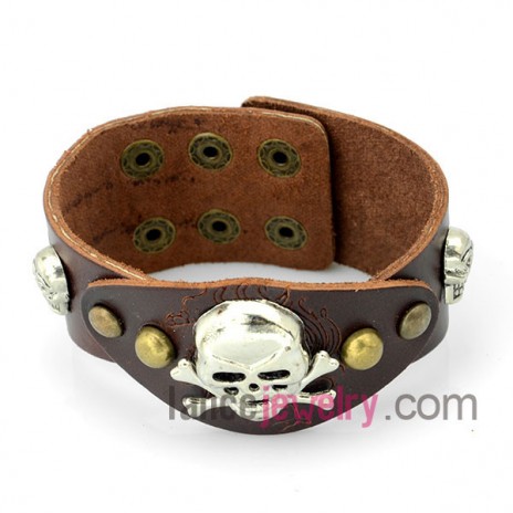 Cool bracelet  with brown patterned leather decorated skeleton and many snap fastener 