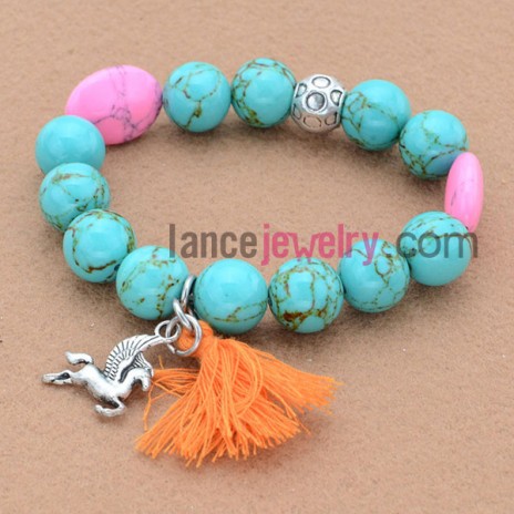Unique design bead bracelet with animal pendant and tassels.
