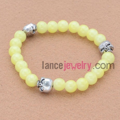 Trendy stone bead bracelet with alloy skeleton pendant.