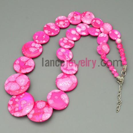 Deep pink necklace, with bigger shells from top to bottom