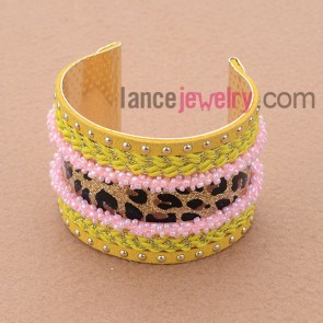 Delicate iron bangle with pink beading,metal chain and cord decoration