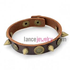 Trendy bracelet with brown leather decorated many different shapes of rivet and snap fastener 
