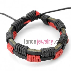 Delicate bracelet decorated with  leather wrapped around  red and black rubber

