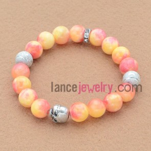 Gradient color stone bead bracelet with alloy decoration.