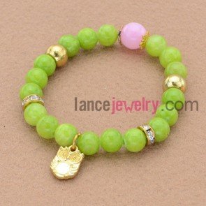 Striking green color bead bracelet with rhinestone and owl pendant decoration.