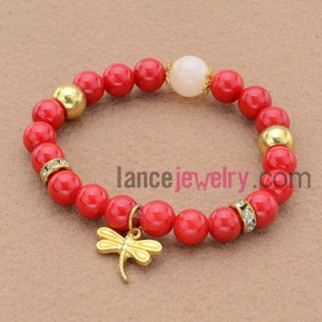 Classic rhinestone decorated bead bracelet with dragonfly pendant.
