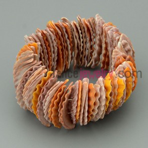 A system of yellow colored fan shell bangles