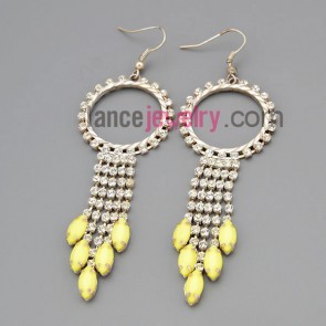 Striking earrings with claw chain rings decorate many rhinestone and light yellow pendant

