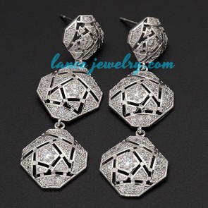 Distinctive brass alloy earrings decorated with special shape pendants
