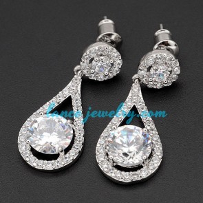 Traditional brass alloy earrings decorated with cubic zirconia pendant
