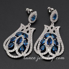 Unusual brass alloy earrings with blue cubic zirconia decoration 