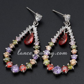 Distinctive drop earrings decorated with red pendants of cubic zirconia