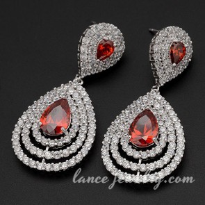 Glittering brass alloy earrings decorated with red cubic zirconia