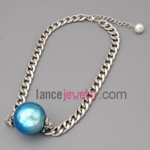 Shiny chain necklace decorated with a blue bead