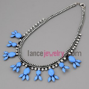 Cute necklace with silver metal chain and brass parts and shiny rhinestone and blue resin with special shsape