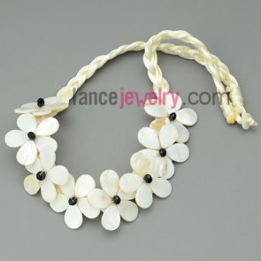Yellowish wax cord necklace with eight pearl white shell flowers 