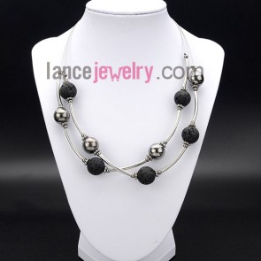 Cool necklace decorated with black lava and brass