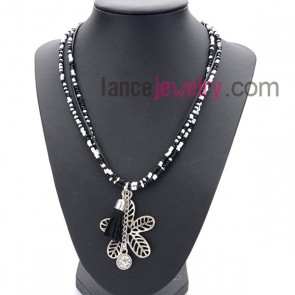 Fashion necklace with many small size
measles in black and white  and flower pendant 
