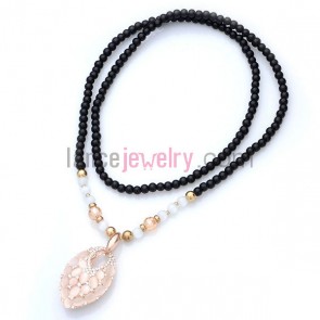 Cat eye ornate oval pendant  ceramic bead strand necklace