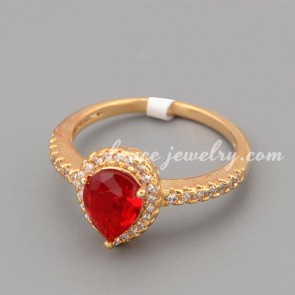 Shiny ring with red cubic zirconia in the drop shape