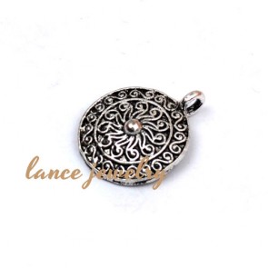Zinc alloy pendant,a round pendant with a small bead in the middle and flower pattern on the face