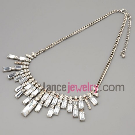 Shiny necklace with silver metal chain and brass parts and rhinestone and transparent crystal 