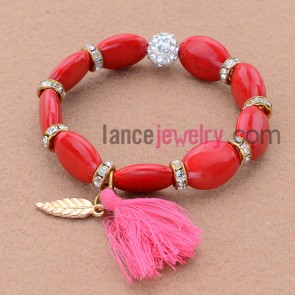 Gorgeous red color and nice rhinestone bead bracelet with leaf pendant and tassels.