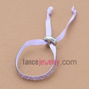 Fabric based bracelet with rhinestone beads and plastic clasp