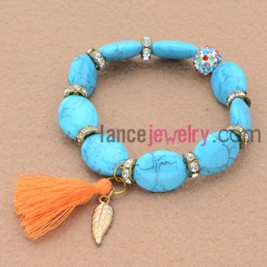 Multicolor rhinestone and alloy findings decorated bead bracelet with leaf pendant and tassels.