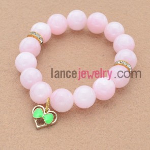 Elegant pink color bead bracelet with heart pendant.