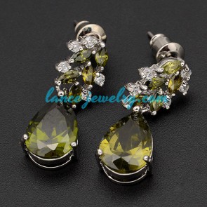 Antique brass alloy earrings decorated with green cubic zirconia