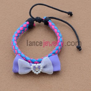 Leather based bracelet with bow tie decoration