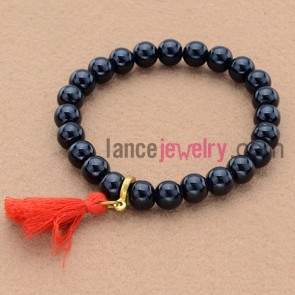 Classic dark color bead bracelet with tassels.