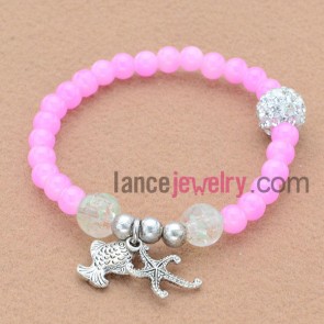 Fantastic pink color and delicate rhinestone bead bracelet with starfish and fish pendant.