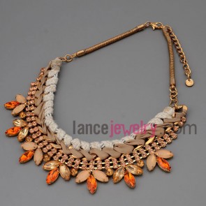 Statement necklace with gold metal chain and cord and alloy part decorate rhinstong and crystal