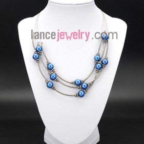 Glittering necklace decorated with blue glass pearls 
 